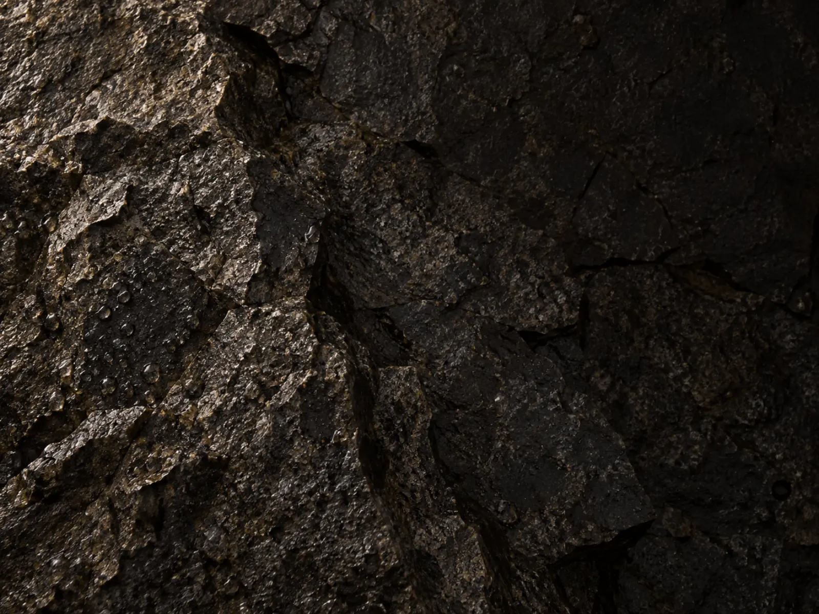 Hand-split volcanic basalt showing its crystalline fracture face under raking light